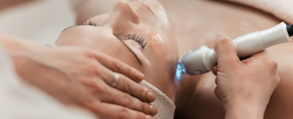 Woman getting laser and ultrasound face treatment